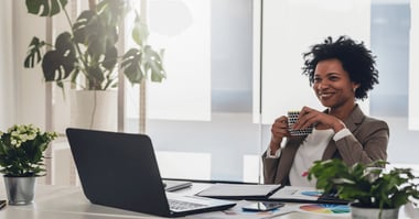Digital dexterity - female executive considers laptop - Forbes Councils