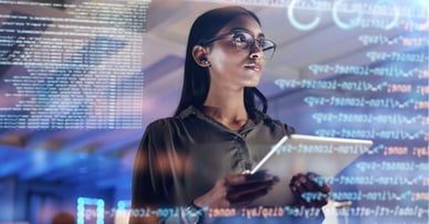 Managing Cybersecurity Risks in Finance: A Guide For CFOs - Woman With Glasses Holding Tablet