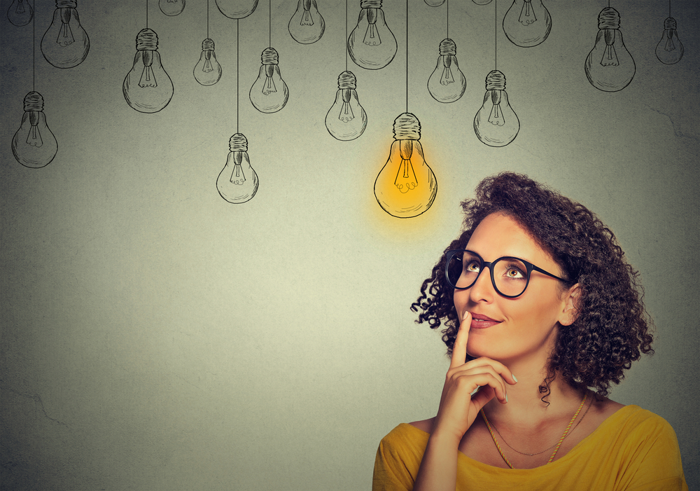 Light bulbs indicating ideas above woman executive's head